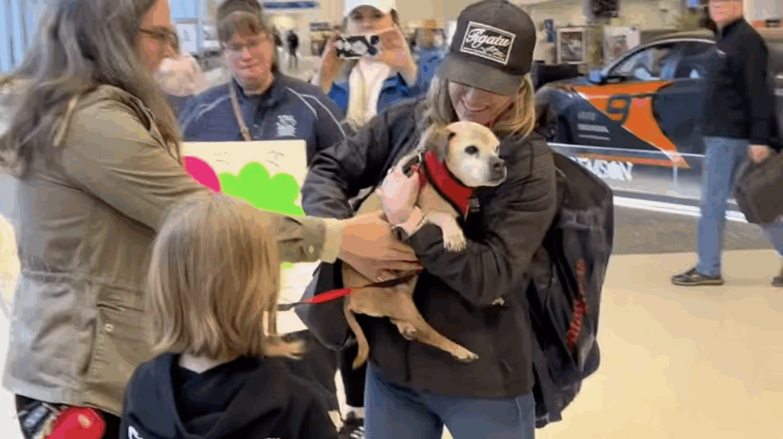 Woman hugging her missing dog at the airport