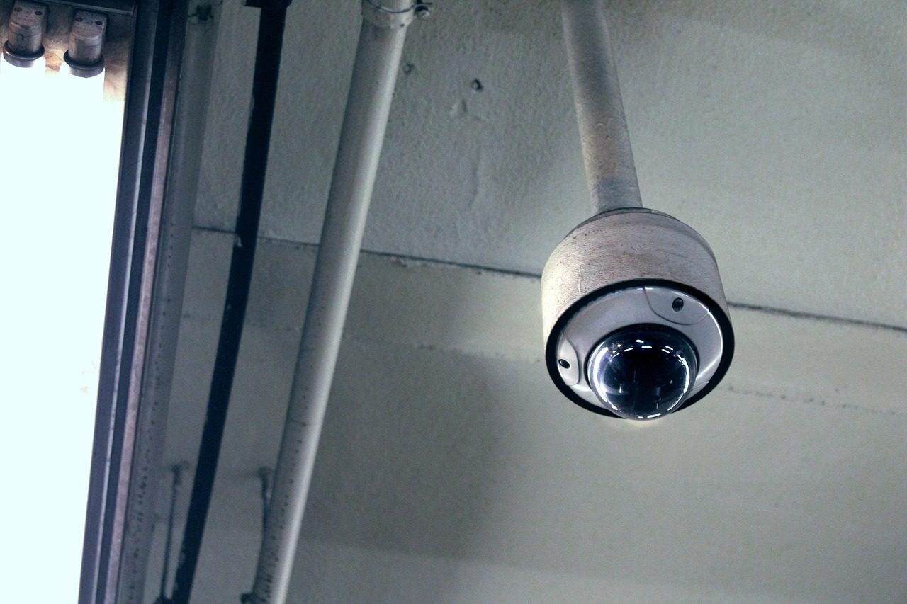 A dome security camera mounted on a ceiling