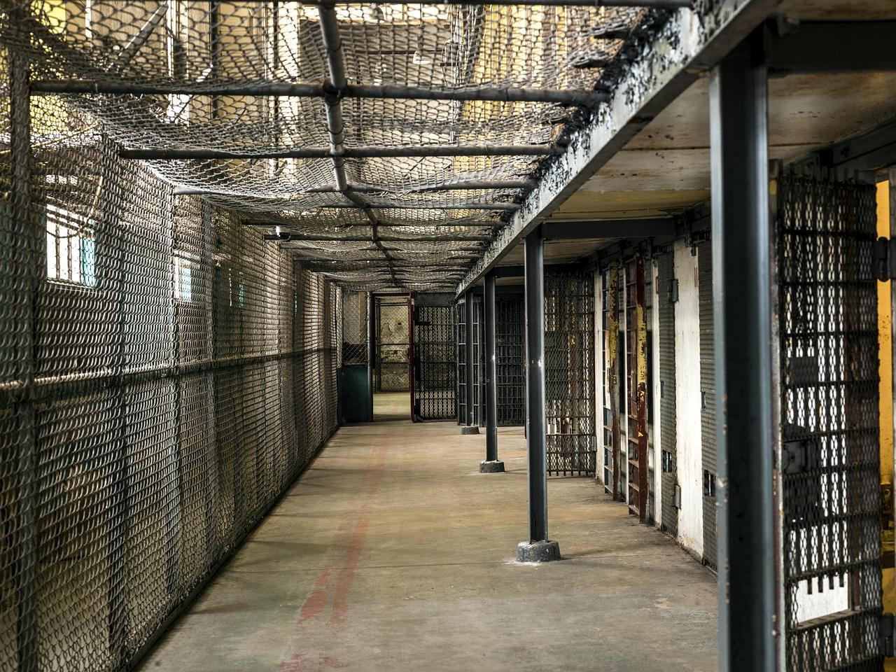 Illustrative stock photo of an empty prison cell wing with barred doors