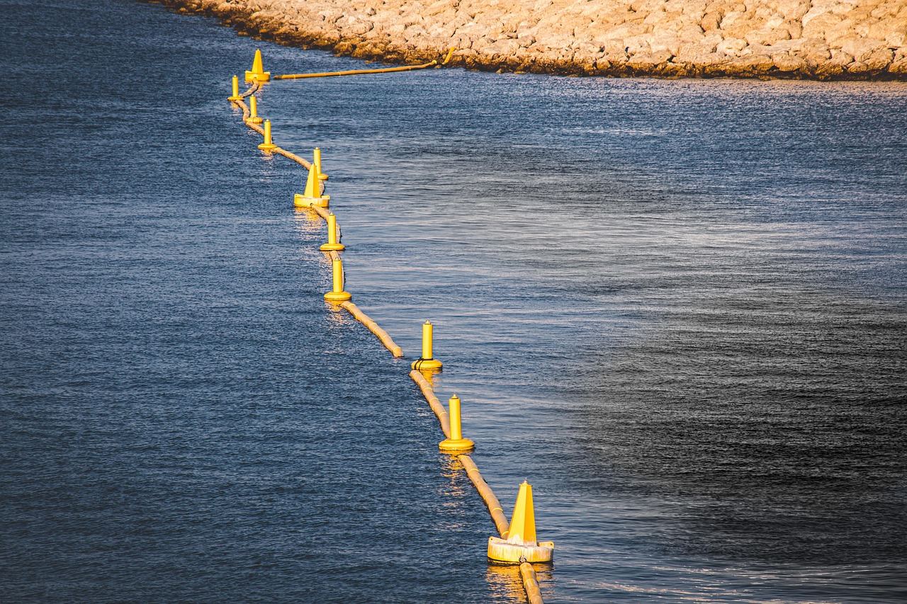 Yellow oil containment boom floating on open water